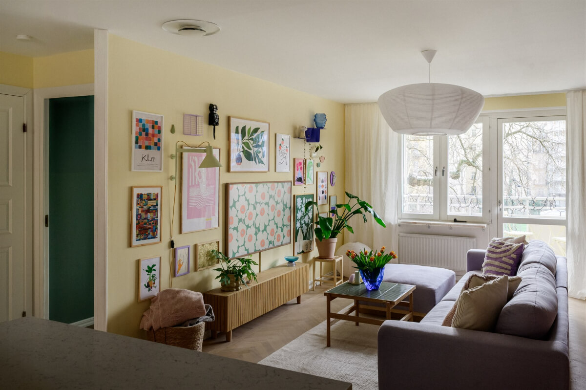 Colorful Rooms in a Bright Two-Bedroom Stockholm Apartment 4 yellow living room gallery wall