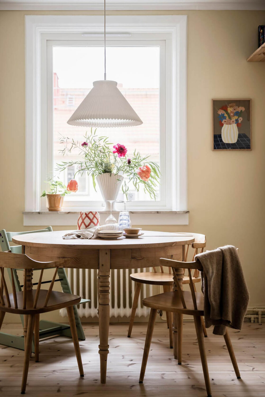 Timeless Charm and Contemporary Design in a 1930s Duplex Apartment 8 yellow walls wooden dining table