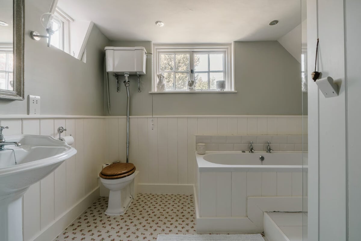 Serene Colors and Historic Elements in an Elizabethan Home in Wiltshire 20 bathroom light gray walls wood paneling
