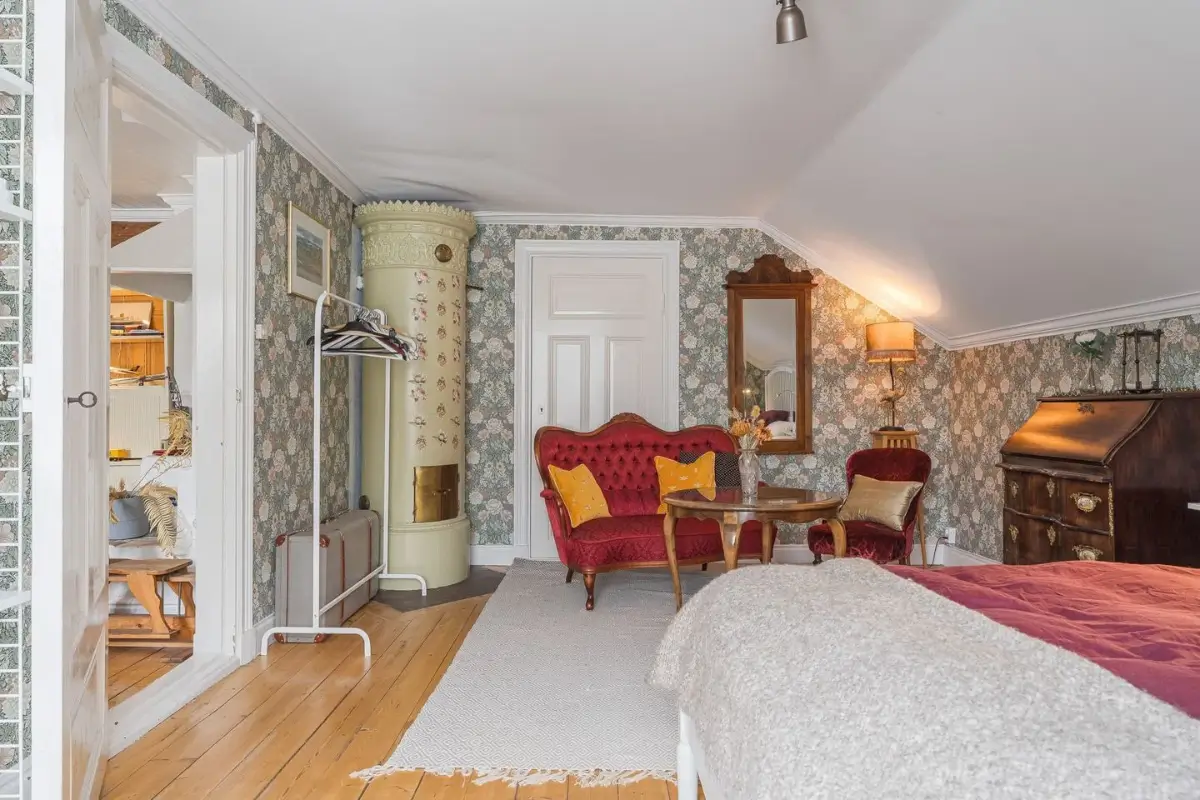A Cozy Country House in Sweden Filled with Wallpapers 28 bedroom antique seating area fireplace