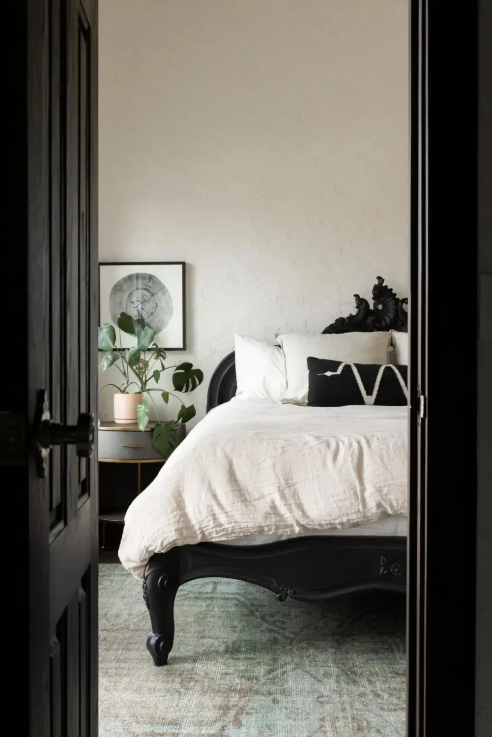 Spanish Hacienda Meets Custom Craftsmanship in a Colorado Home 34 bedroom black ornate bedframe
