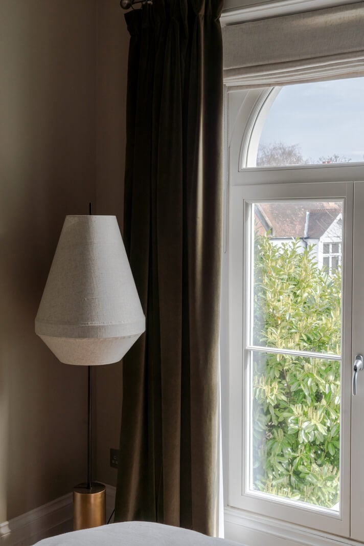 A Serene Color Palette and Arched Windows in a Small English Apartment 14 bedroom detail
