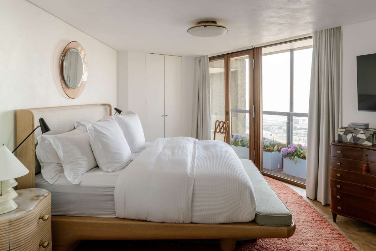 Oak and Marble in a Spectacular Brutalist Apartment in London 16 bedroom oak bedframe large rug