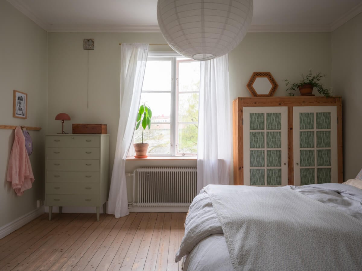 A Soft Color Palette and a Charming Kitchen in a Swedish Apartment 22 bedroom wooden floor large window