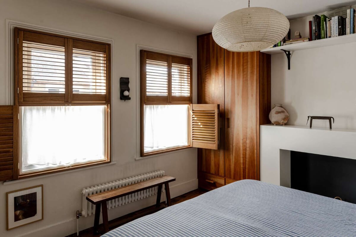 Reclaimed Materials and Custom Storage in a Serene London Home 14 bedroom wooden shutters built-in wardrobes