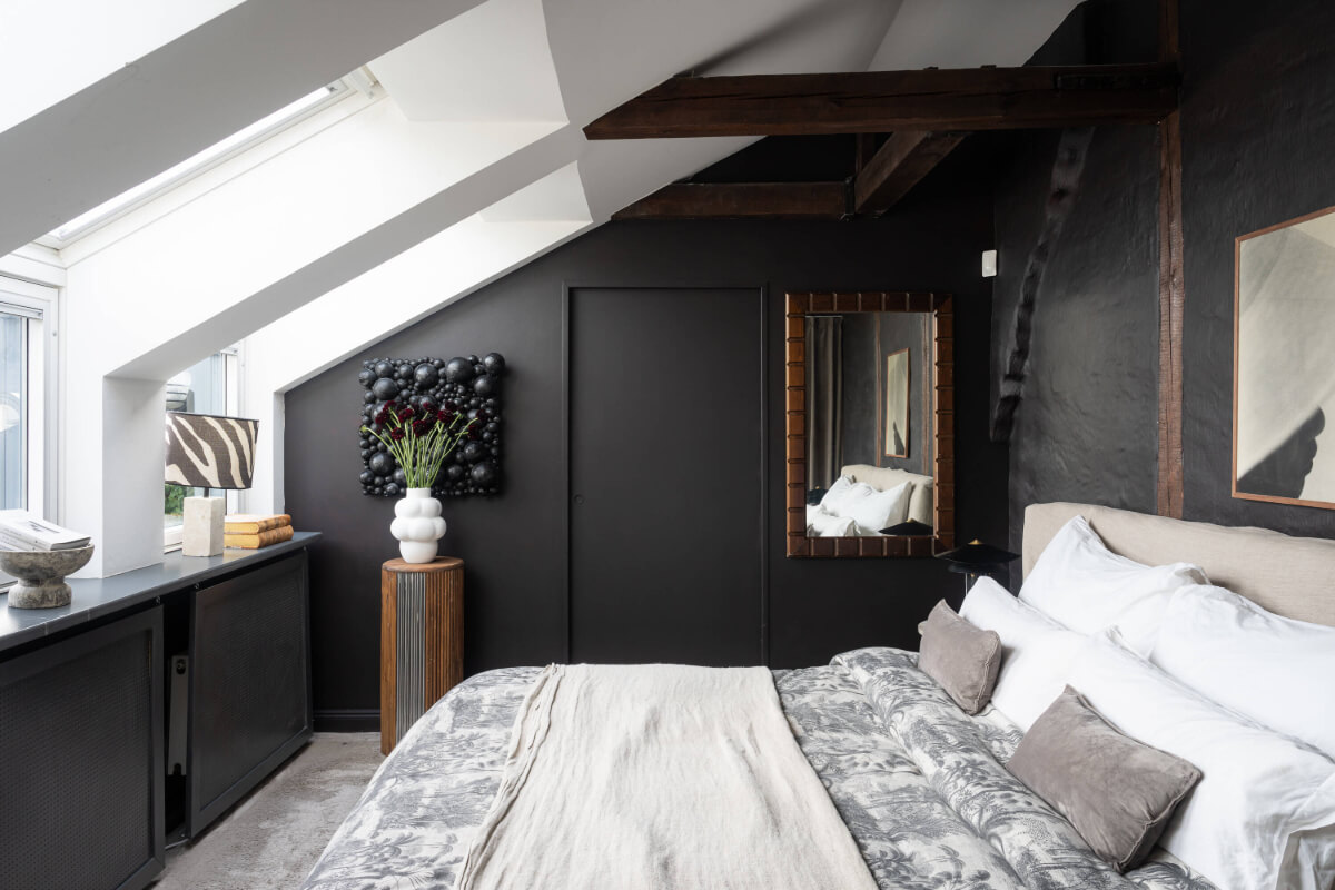 A Stylish Black and White Penthouse Apartment in Stockholm 12 black bedroom slanted ceiling skylights wooden beams