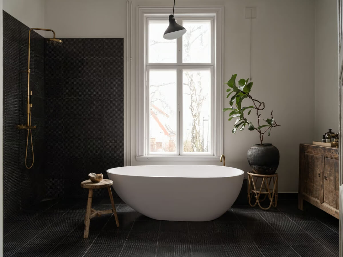 Artilleriet Co-Founder is Selling Her Art Nouveau Villa in Sweden 17 black tiled bathroom freestanding bath
