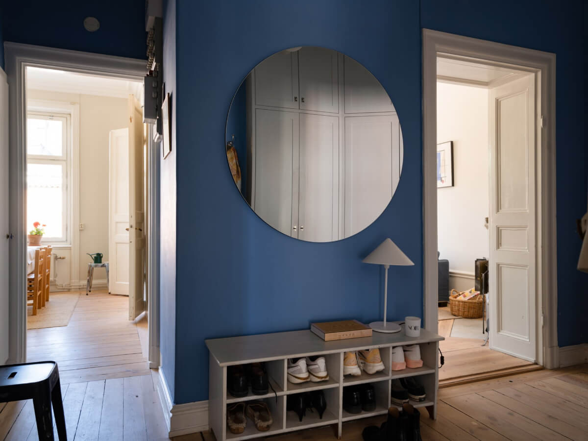 Turn-of-the-Century Charm and Site-Built Storage in a Stockholm Apartment 28 blue hall large round mirror shoe storage