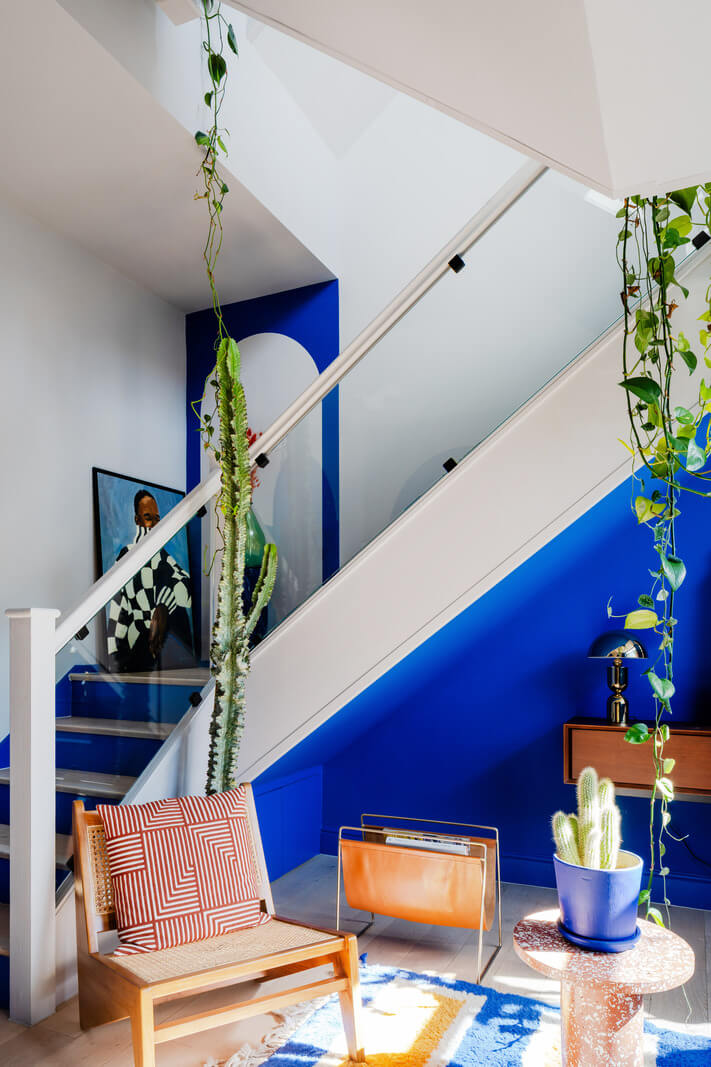 Arched Shapes and Hand-Painted Murals in a Joyful London Townhouse 7 blue hall staircase