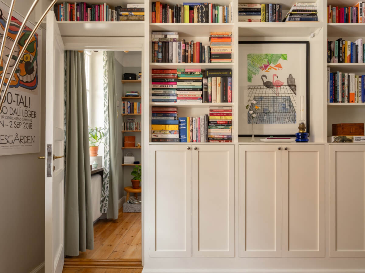 A Small, Cozy Apartment with Built-in Storage and Bookshelves 13 bookshelves around door