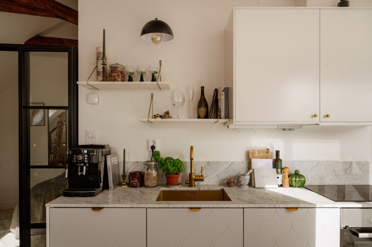 A Bright Attic Apartment with Exposed Beams and a Roof Terrace 7 brass sink kitchen shelves
