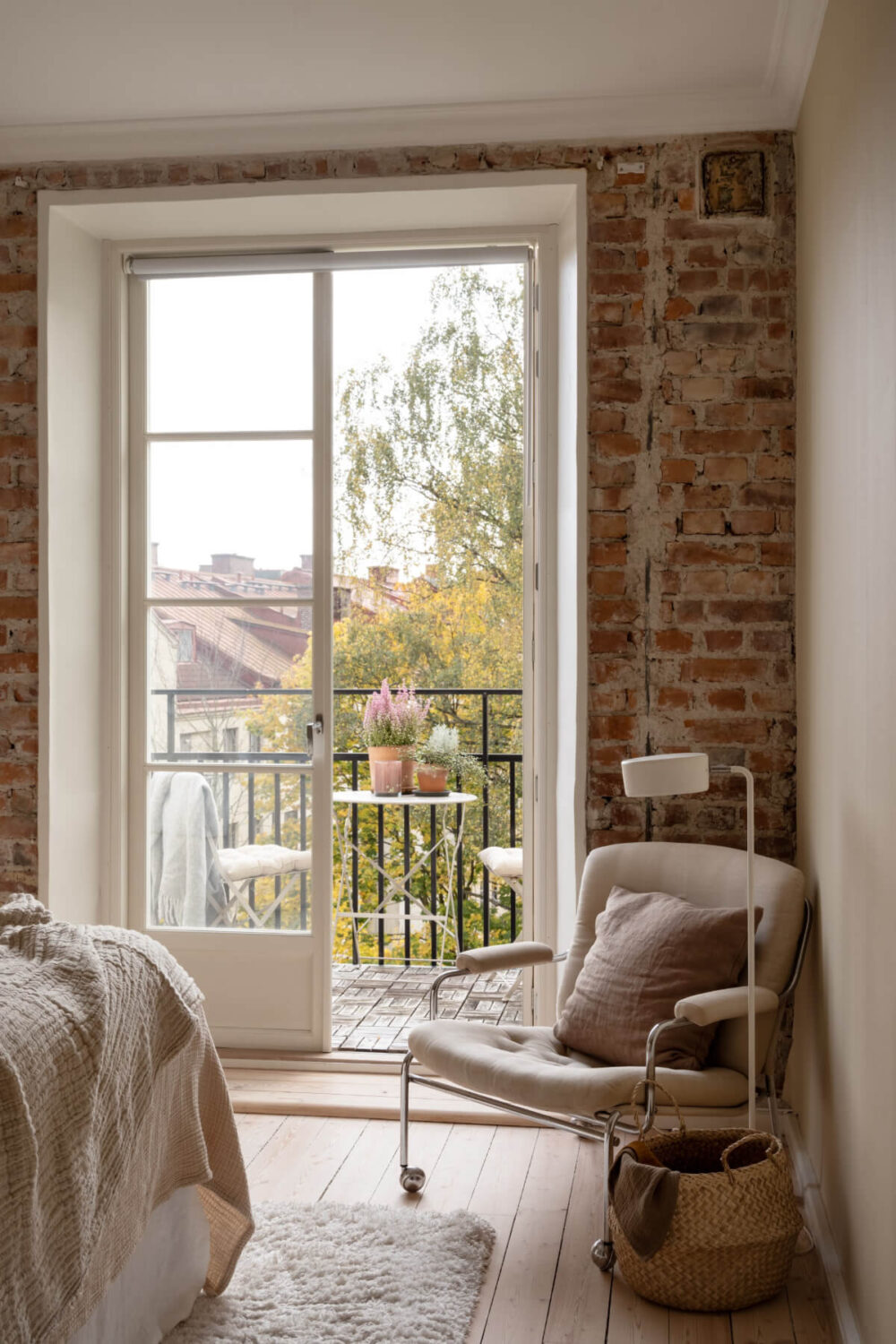 A Beige Color Palette and Built-in Bookshelves in a 1920s Apartment 12 brick wall balcony bedroom