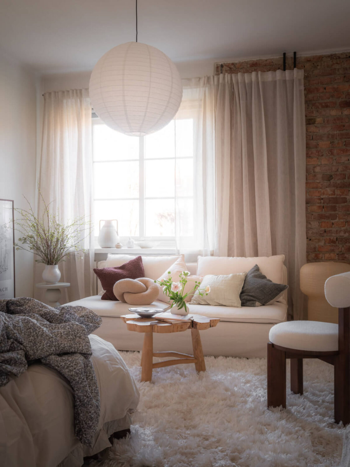 A Light-Colored Studio Apartment with a Cozy Kitchen 3 brick wall scandi studio apartment