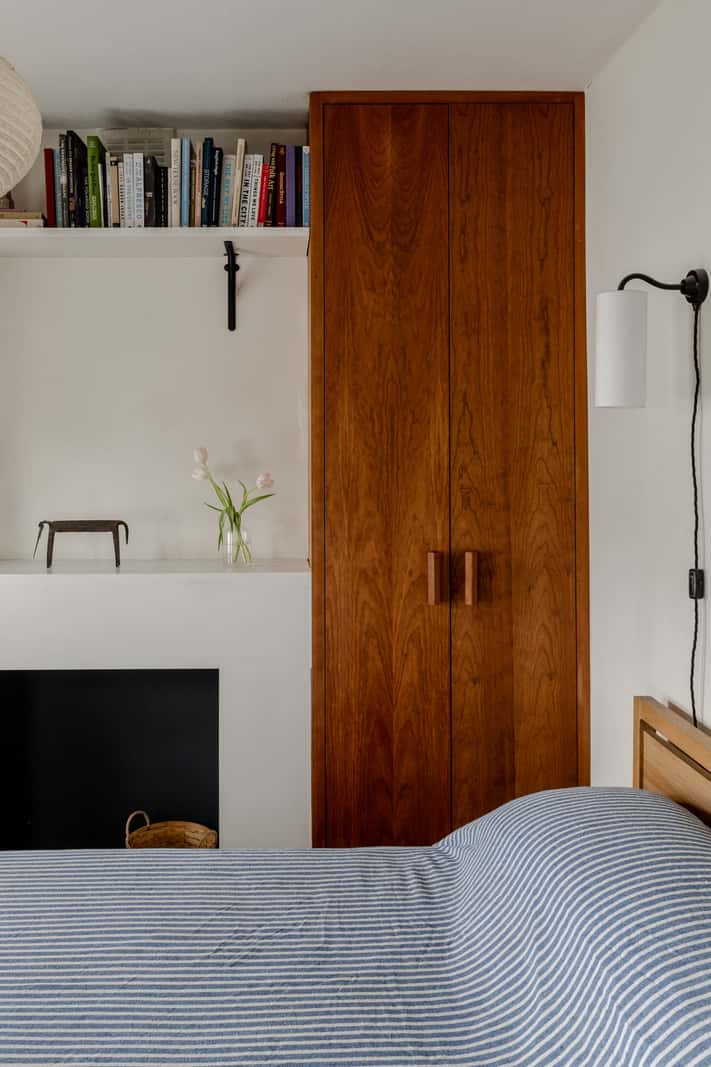 Reclaimed Materials and Custom Storage in a Serene London Home 15 built-in wardrobes flanking fireplace