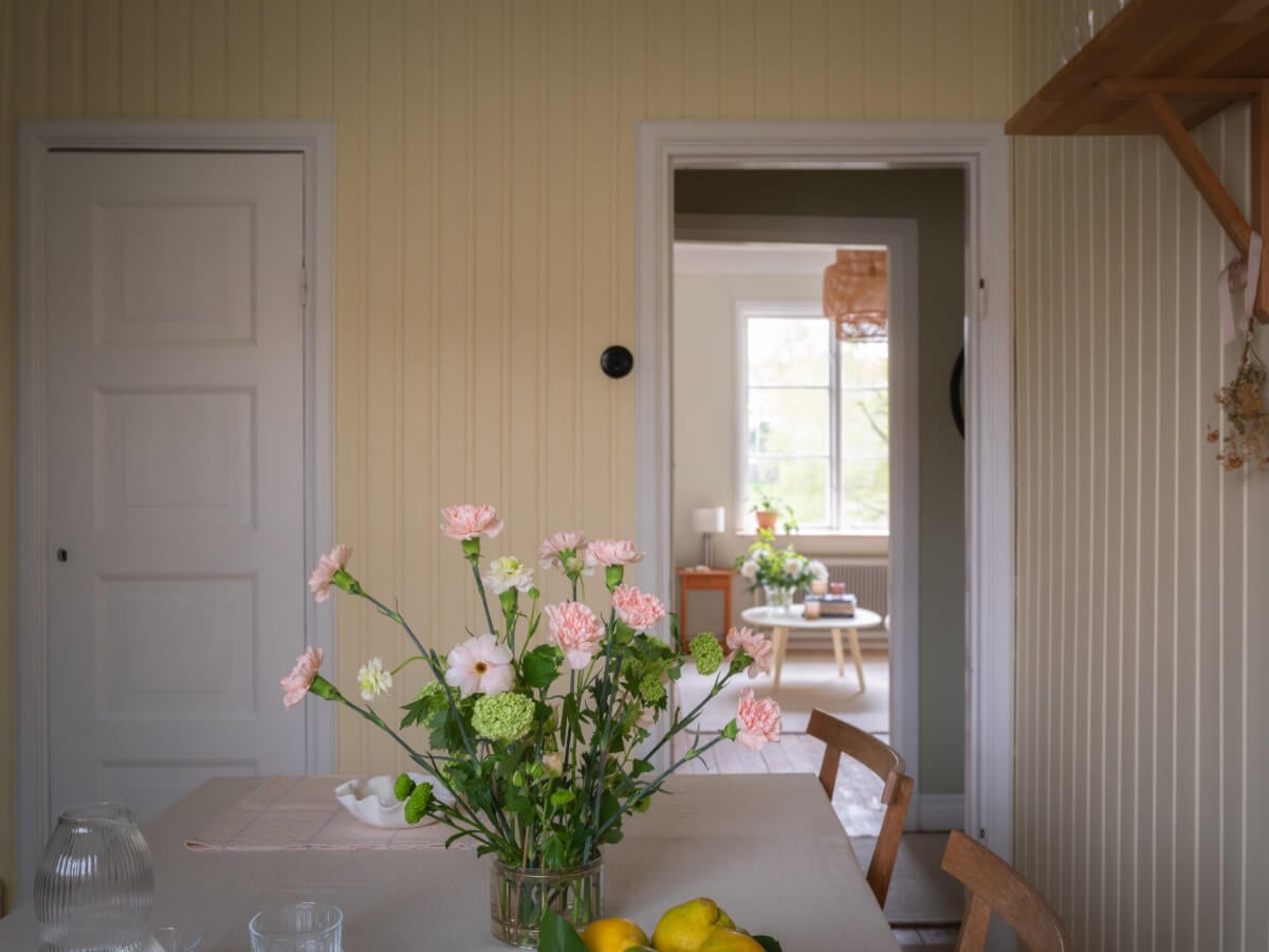 A Soft Color Palette and a Charming Kitchen in a Swedish Apartment 9 butter yellow kitchen walls