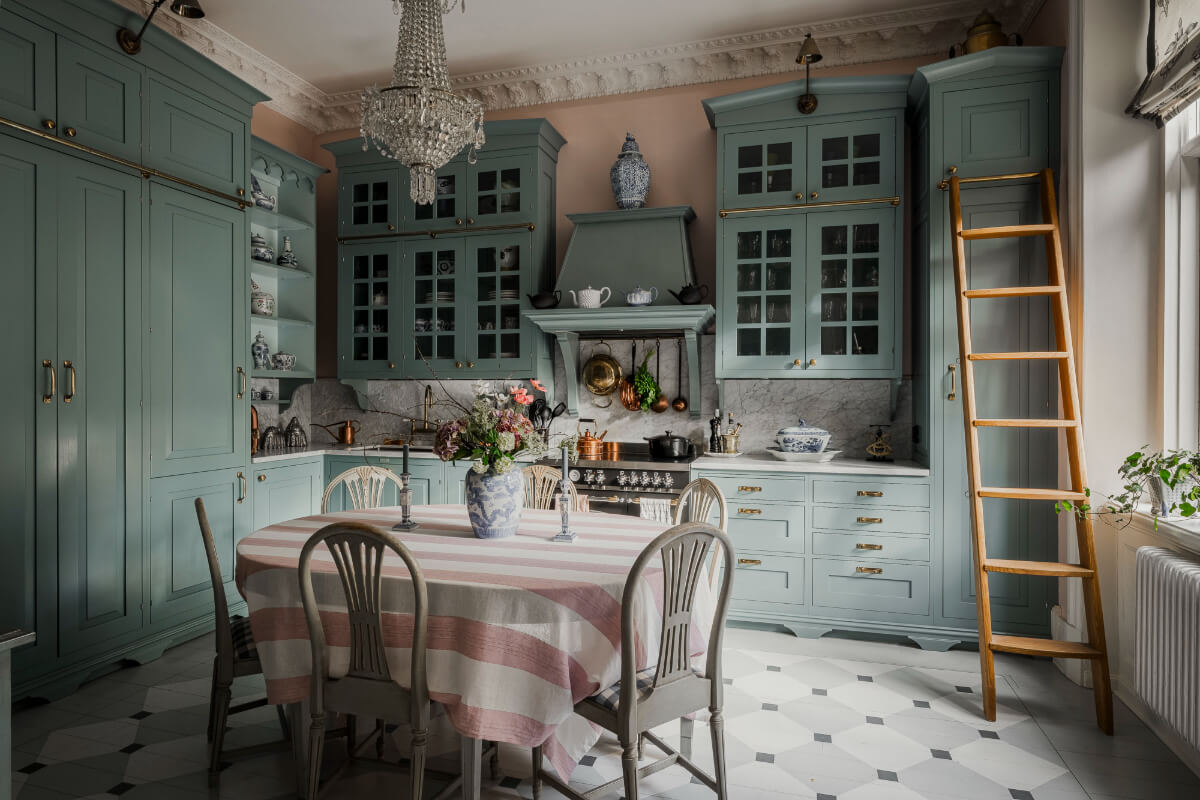 Trend Alert: The 'Soft Kitchen' is 2026's Coziest Interior Trend and It's Here to Stay 13 classic blue kitchen tile floor large dining table striped tablecloth