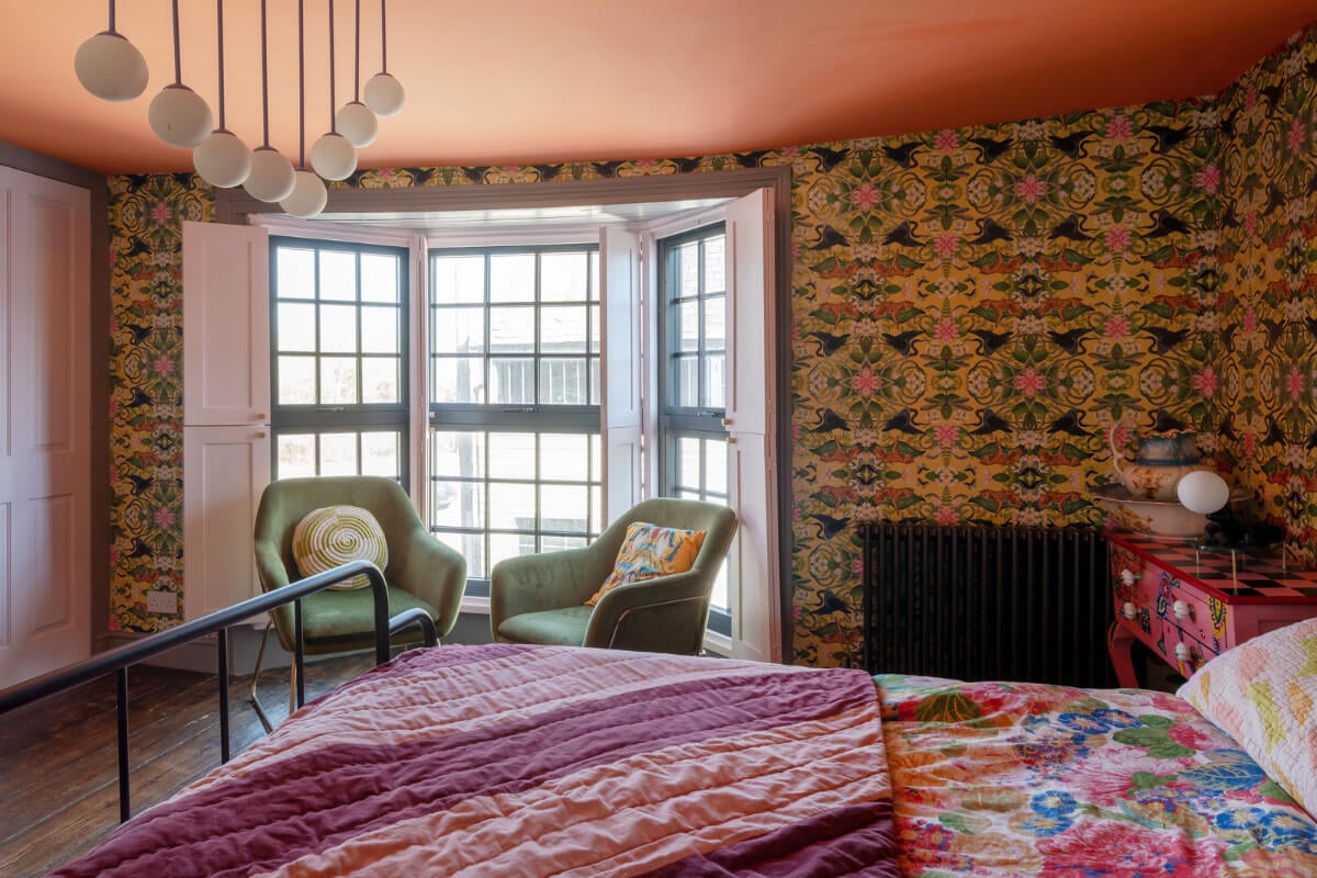 Colorful Design and Historic Features in a Charming English Home 16 colorful wallpaper bedroom bay window built-in wardrobes nordroom