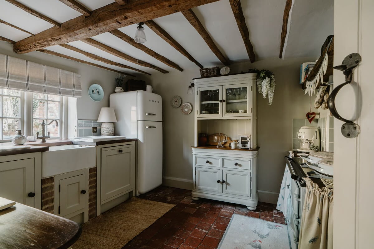 Serene Colors and Historic Elements in an Elizabethan Home in Wiltshire 8 country style kitchen stone floor exposed beams