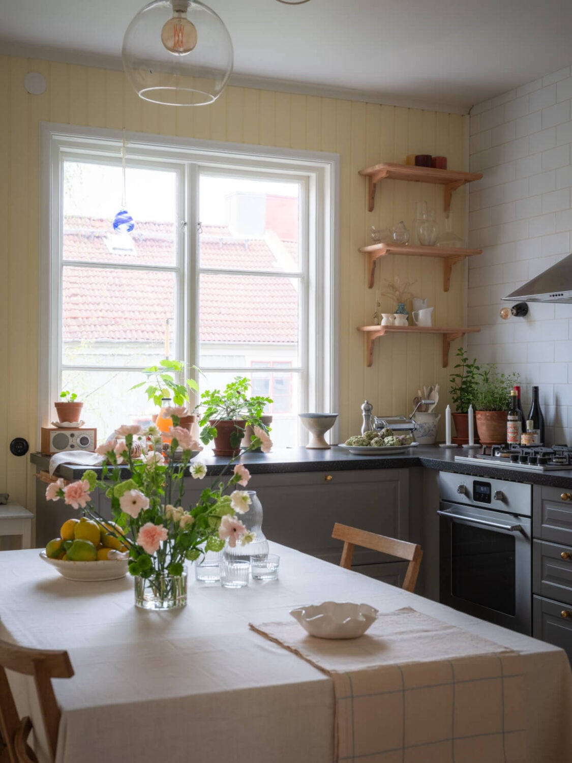A Soft Color Palette and a Charming Kitchen in a Swedish Apartment 2 cozy kitchen large table yellow walls