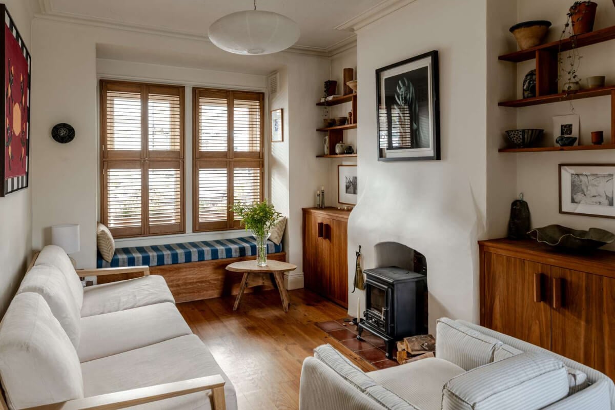 Reclaimed Materials and Custom Storage in a Serene London Home 2 cozy living room built-in storage wood burner