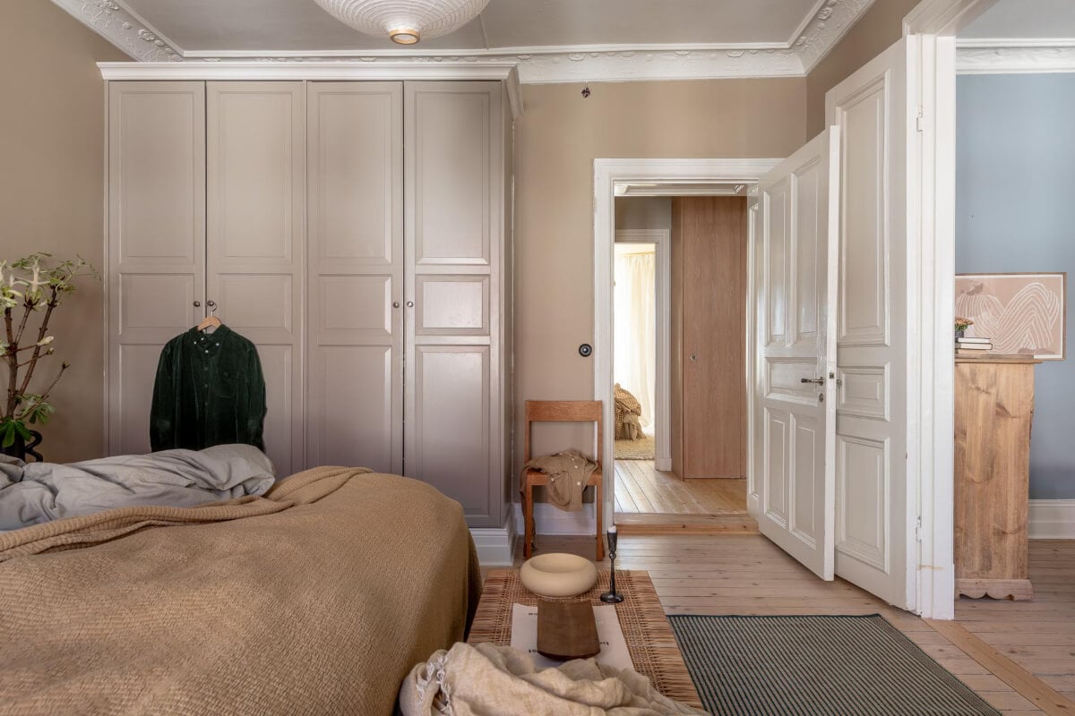 A Natural Color Palette, Period Features, & Grand Rooms in a Swedish Home 15 dark beige bedroom stucco wardrobes