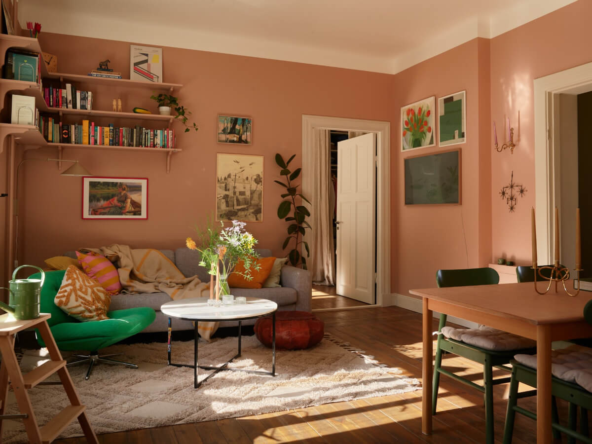 A Nature-Inspired Color Palette in a Stockholm Apartment 2 dark beige walls living room wooden floorboards bookshelves