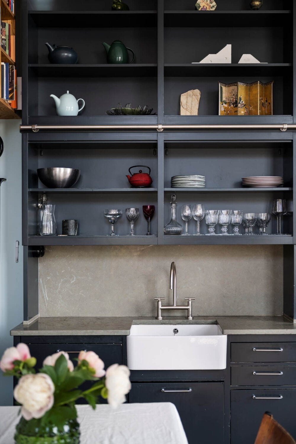Pale Blue Walls and Huge Windows in a Swedish Loft Apartment 7 dark blue open kitchen cabinets