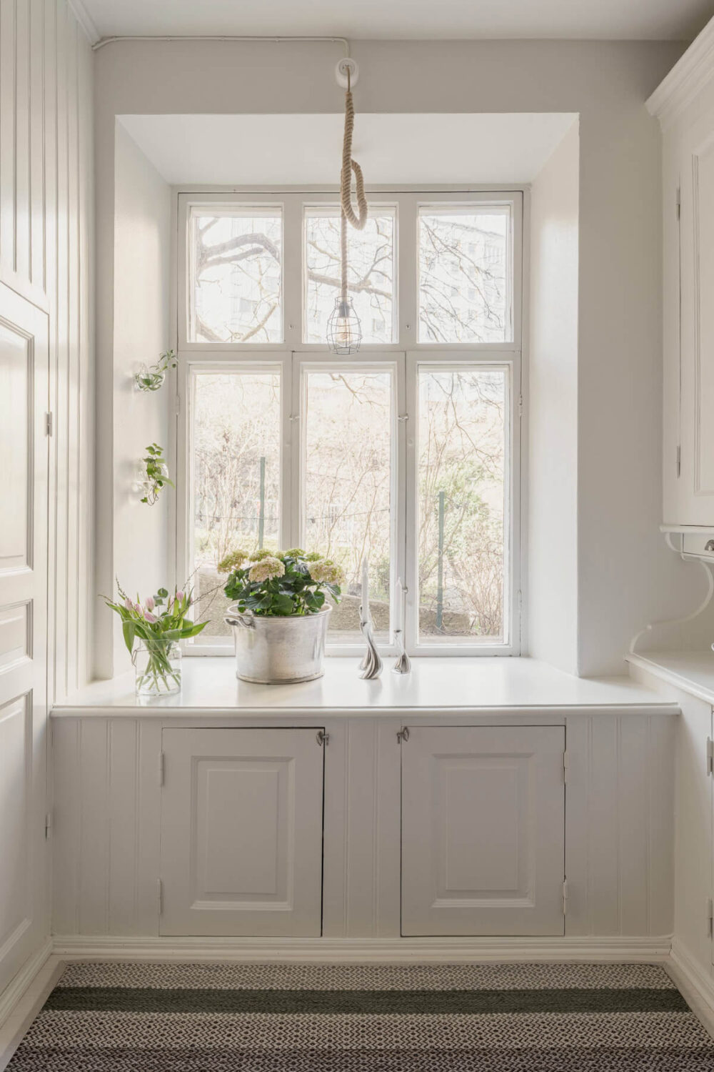 A Bright Swedish Apartment with Period Features and a Green Kitchen 6 deep window niches with cabinets