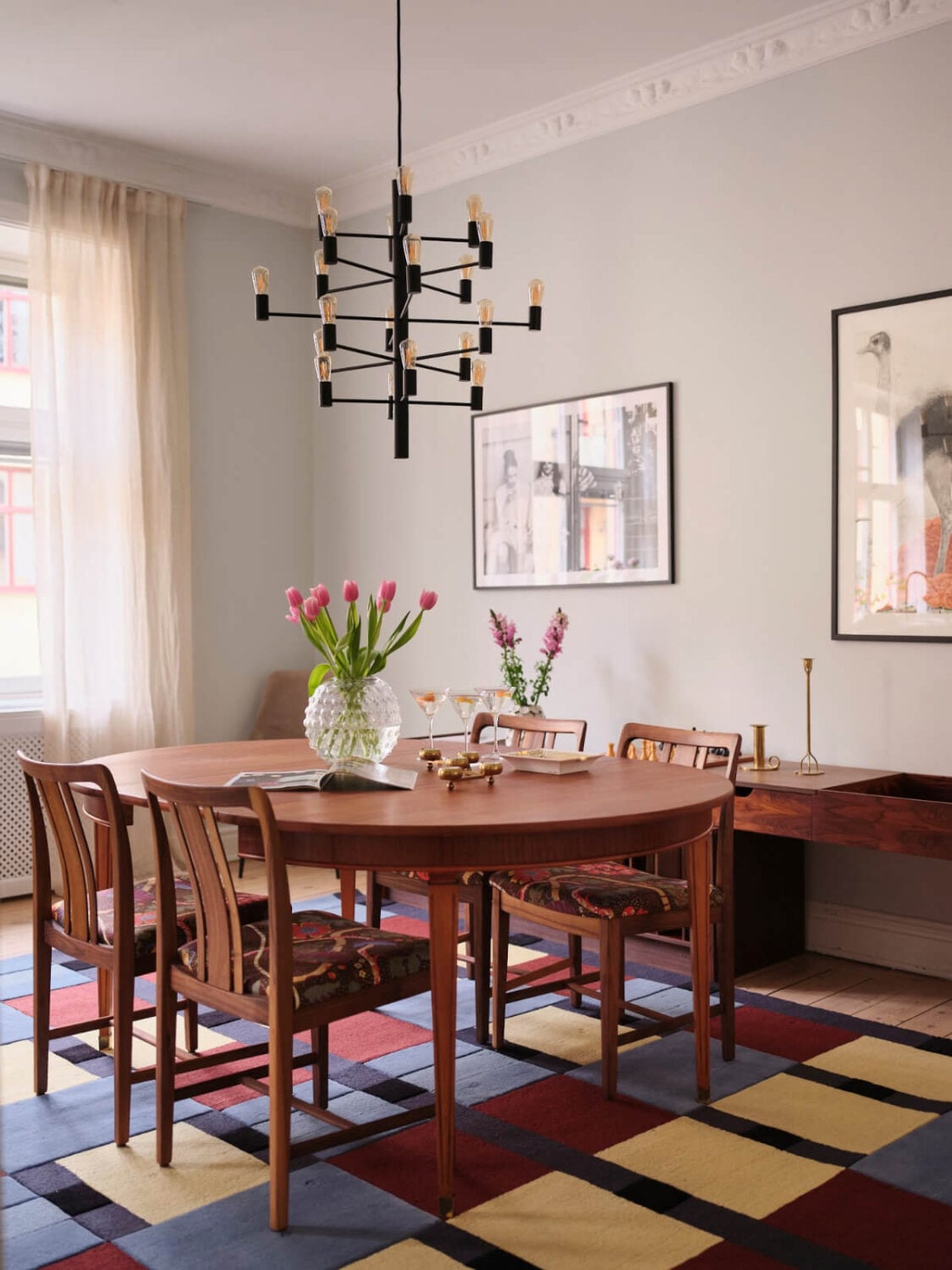 A Spacious Turn-of-the-Century Apartment with Nice Color Accents 8 dining room large wooden table colorful rug