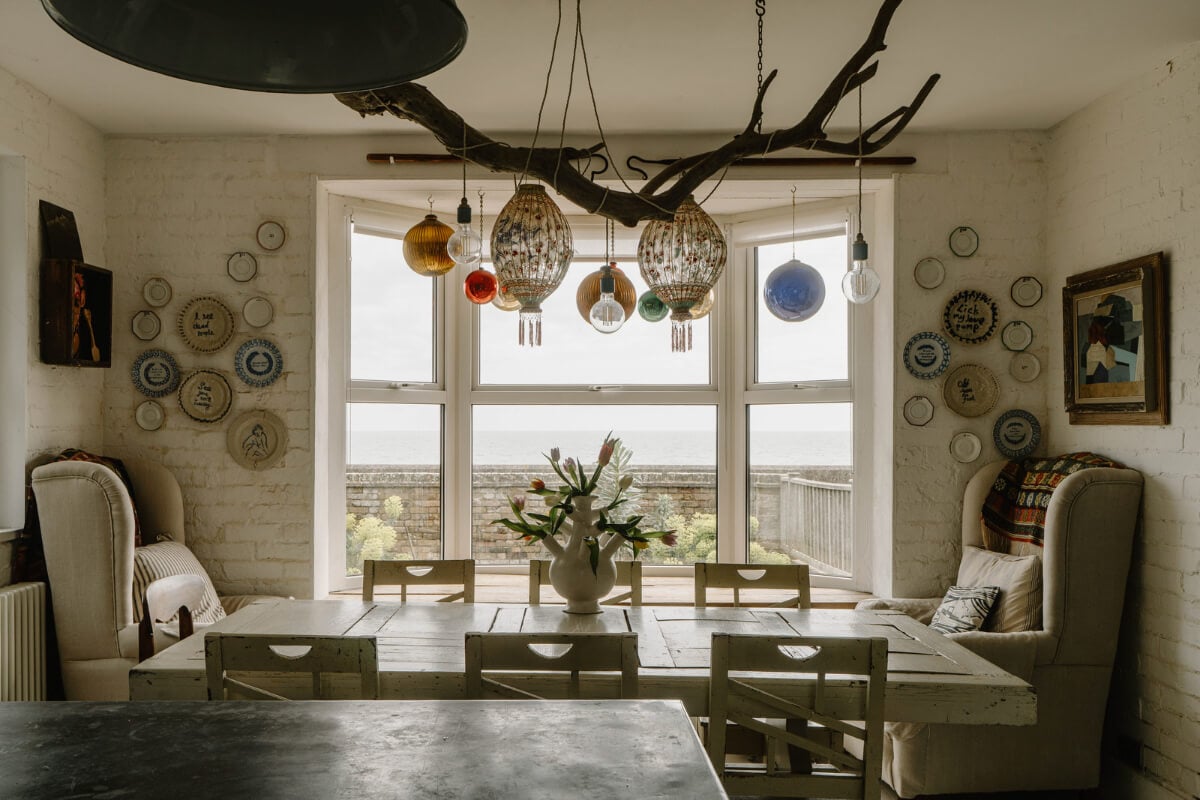 A Bright English Seaside Home Owned by Artists 11 dining table large bay window