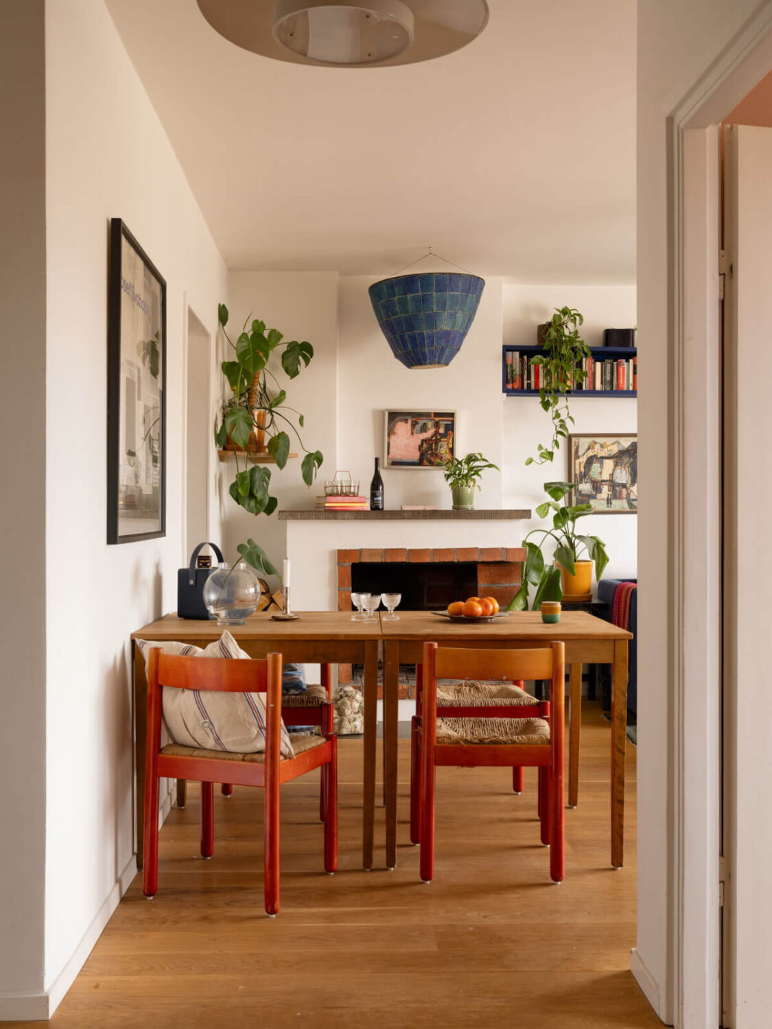 Color Accents in a Renovated Midcentury Apartment in Stockholm 12 dining table red chairs