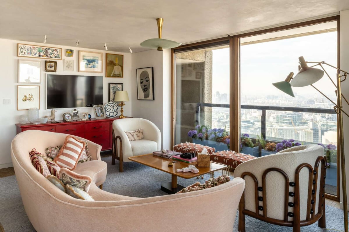 Oak and Marble in a Spectacular Brutalist Apartment in London 3 eclectic living room curved sofa blue rug