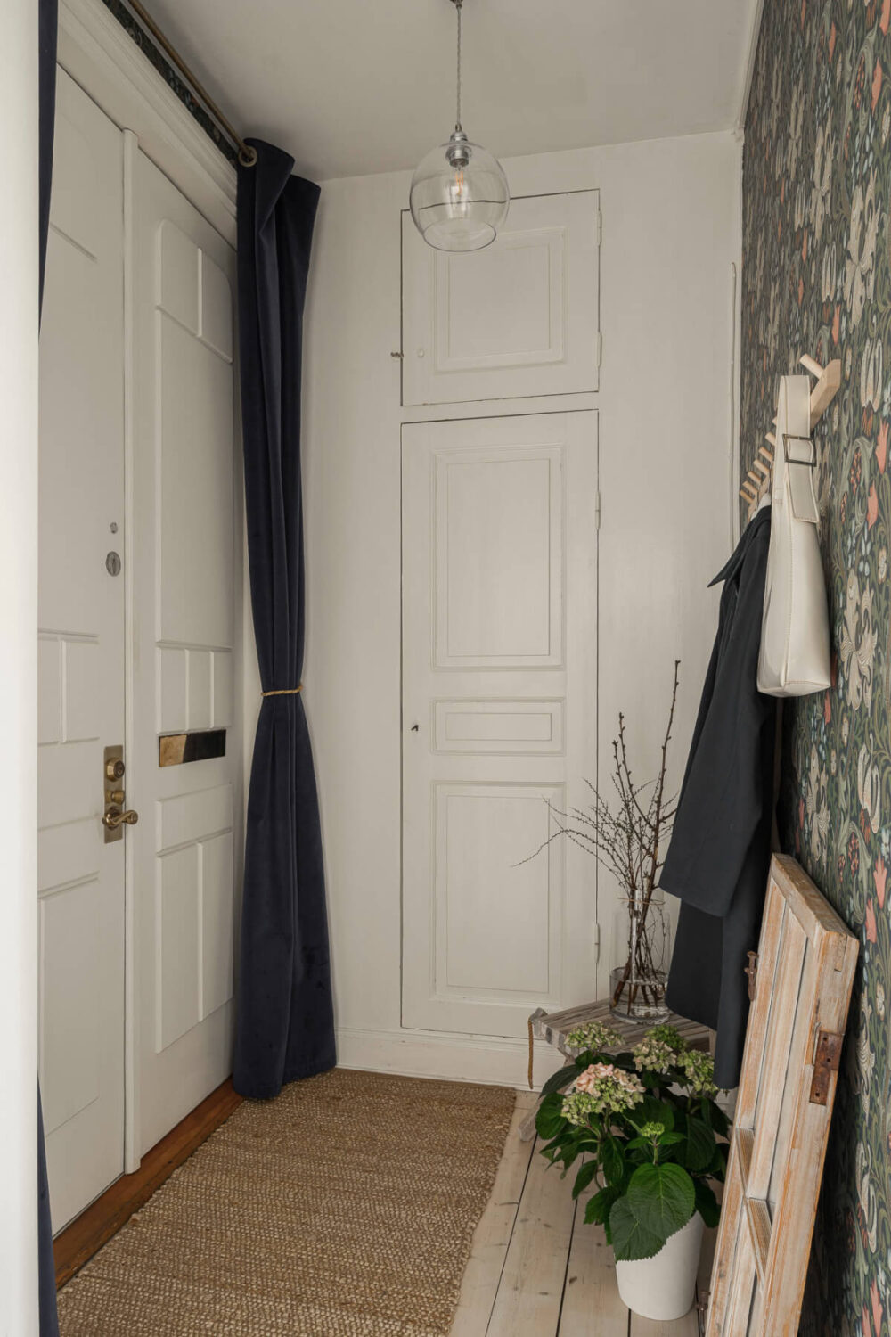 A Bright Swedish Apartment with Period Features and a Green Kitchen 27 entry hall wooden floor wallpaper A Bright Swedish Apartment with Period Features and a Green Kitchen