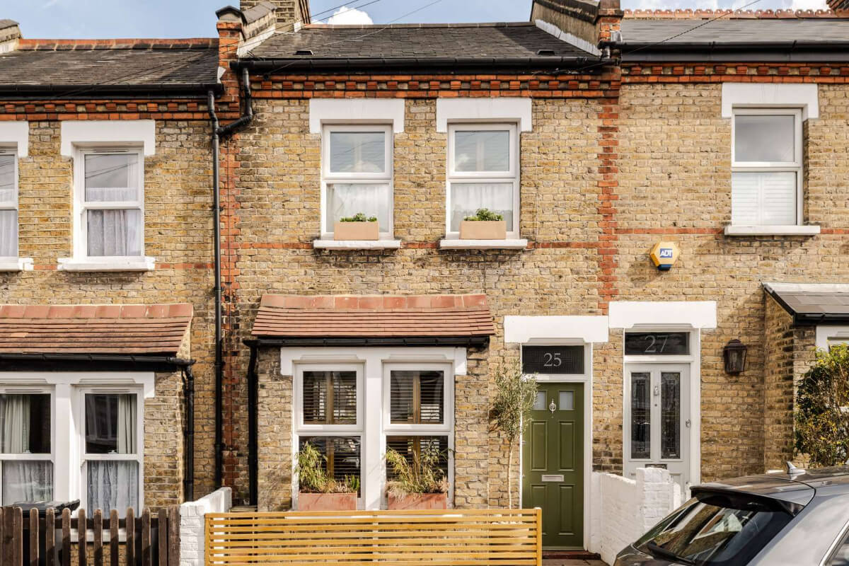 Reclaimed Materials and Custom Storage in a Serene London Home 25 exterior english house green front door