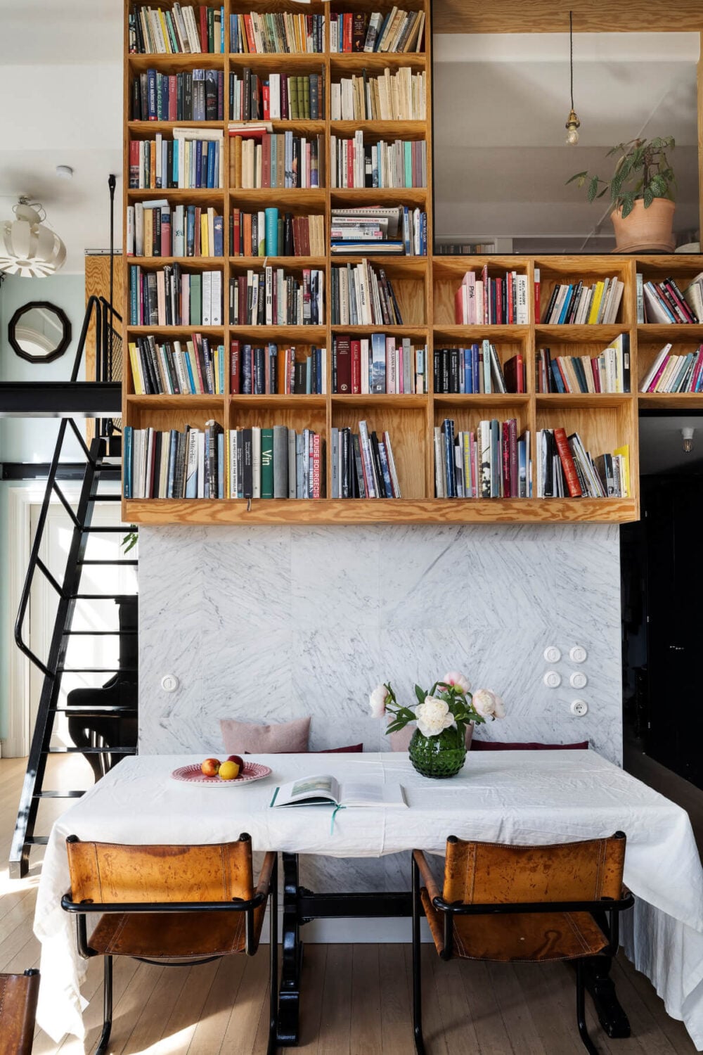 Pale Blue Walls and Huge Windows in a Swedish Loft Apartment 11 floating bookcases above dining table