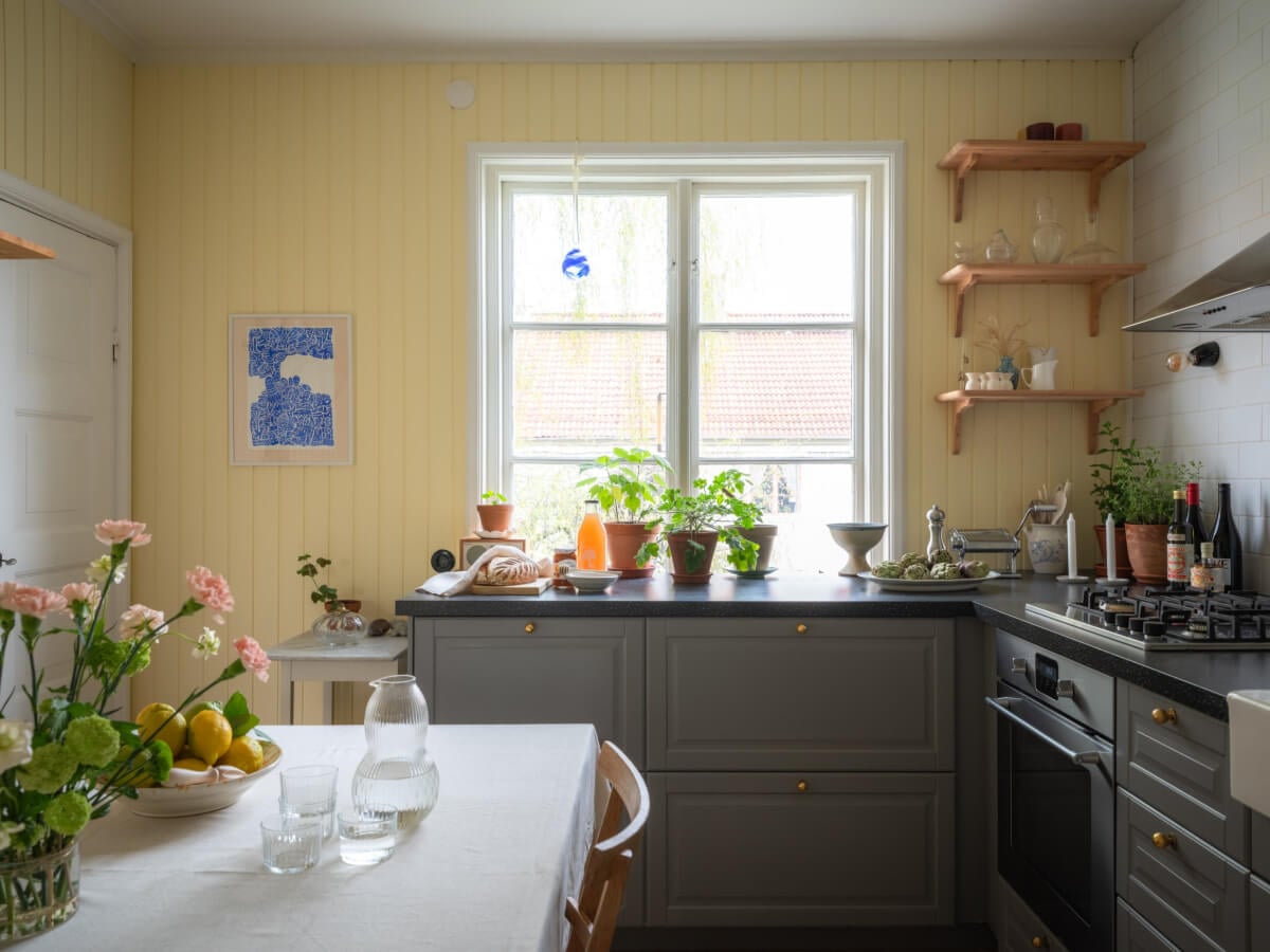 A Soft Color Palette and a Charming Kitchen in a Swedish Apartment 4 gray and yellow kitchen large window