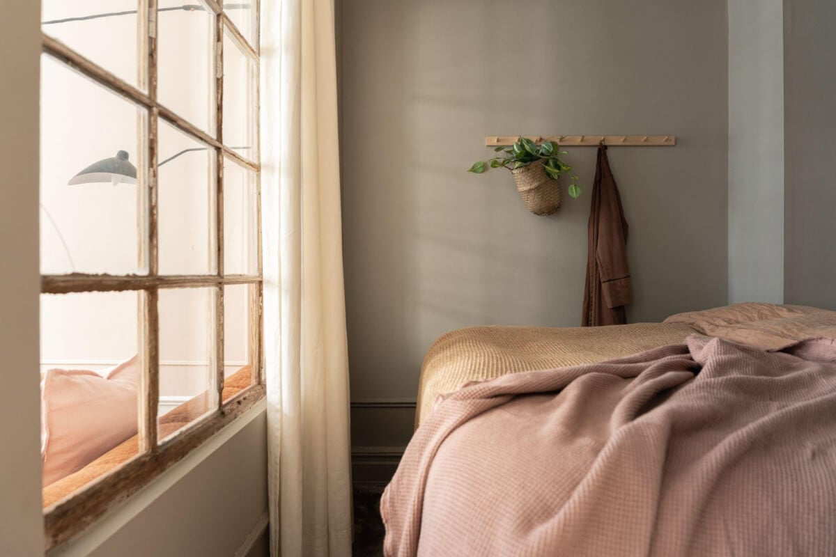 Warm Colors and Classic Elements in a Charming Studio Apartment 7 gray bedroom niche reclaimed window
