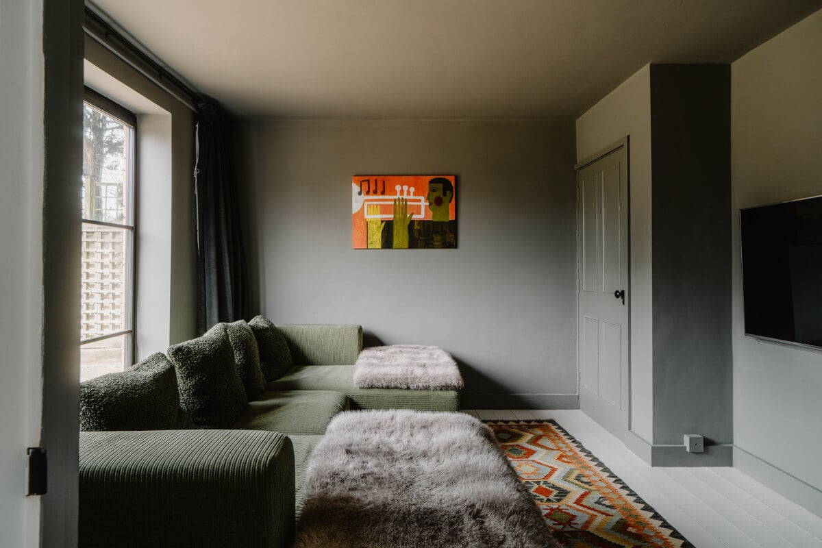 A Bright English Seaside Home Owned by Artists 16 gray snug green sofa