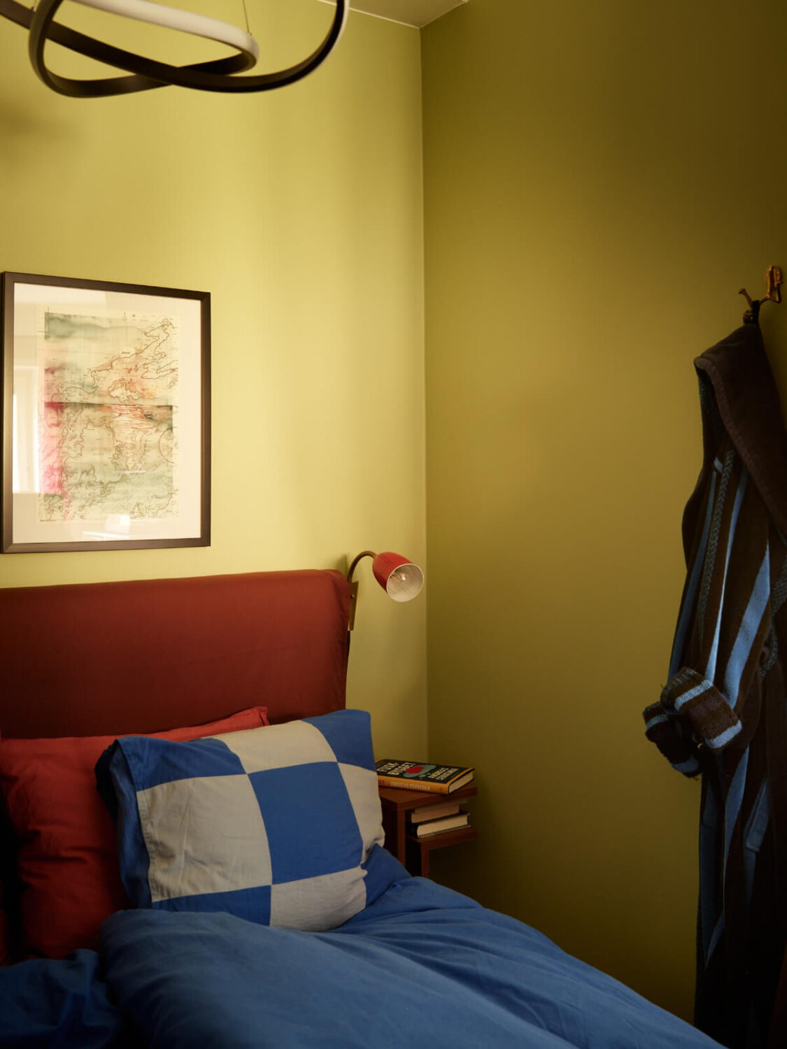 A Colorful Studio Apartment with Smart Storage and A Cozy Bed Niche 9 green and blue bed nook