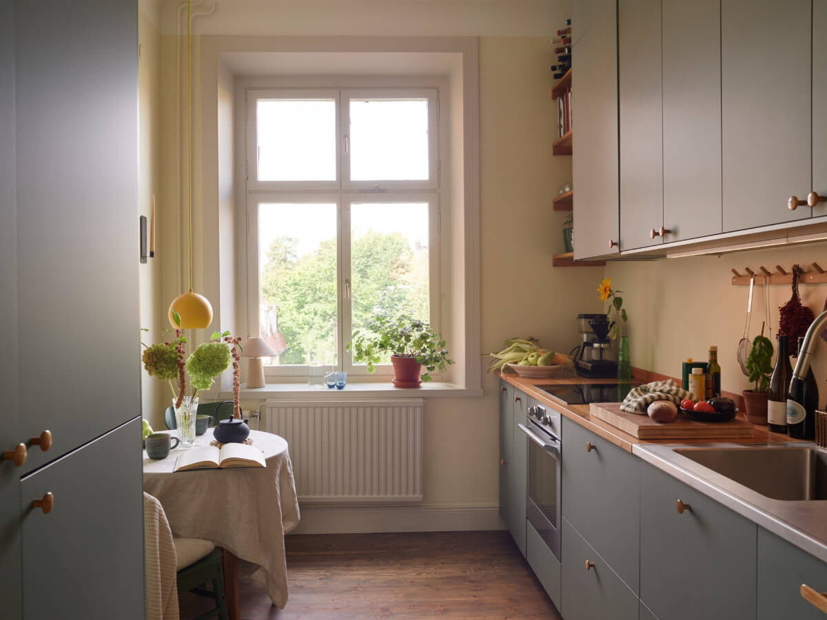 A Nature-Inspired Color Palette in a Stockholm Apartment 8 green kitchen beige walls small table