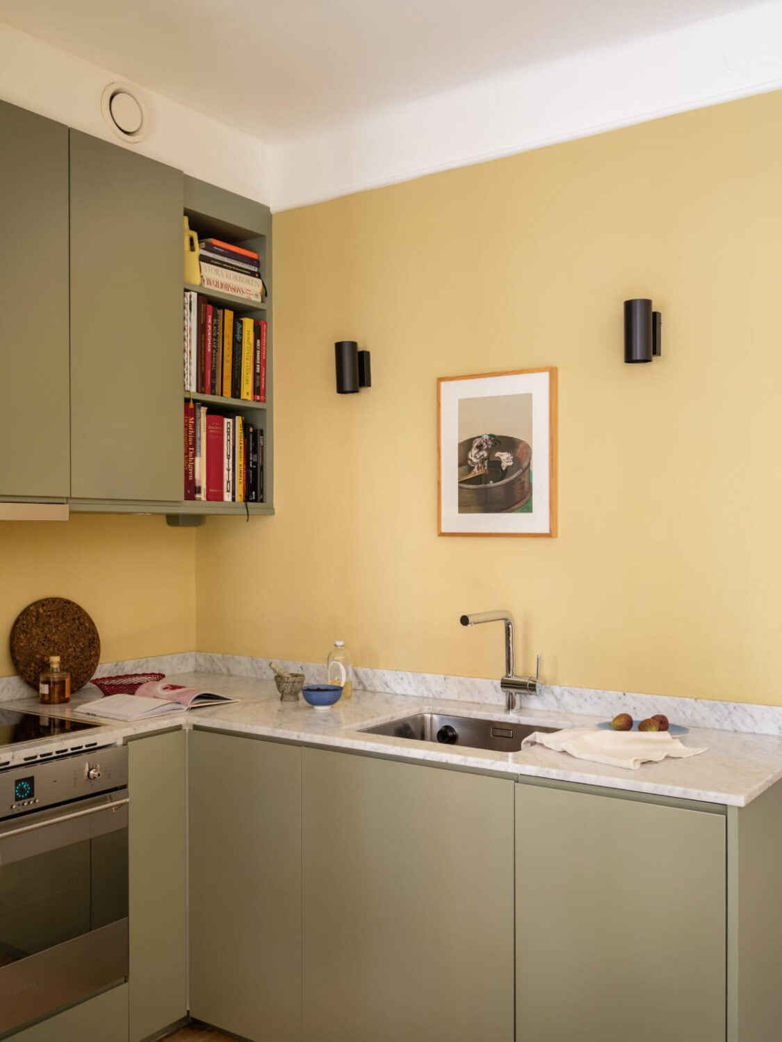 A Yellow and Green Color Palette in a Modern Swedish Apartment 9 green kitchen cabinets yellow wall