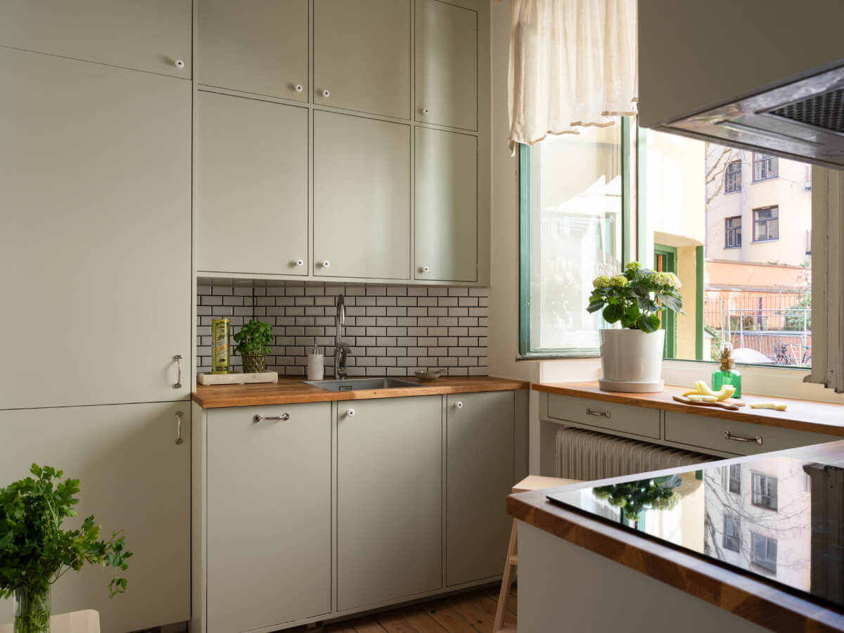 A Small Apartment with Green Color Accents and a Cozy Patio Terrace 21 green kitchen large window