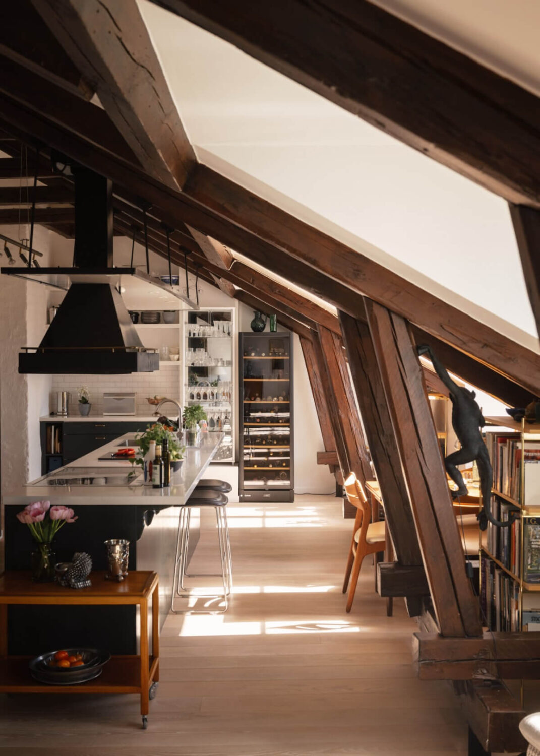 Revisiting a Spectacular Stockholm Penthouse with Exposed Beams 12 green kitchen with bar seating
