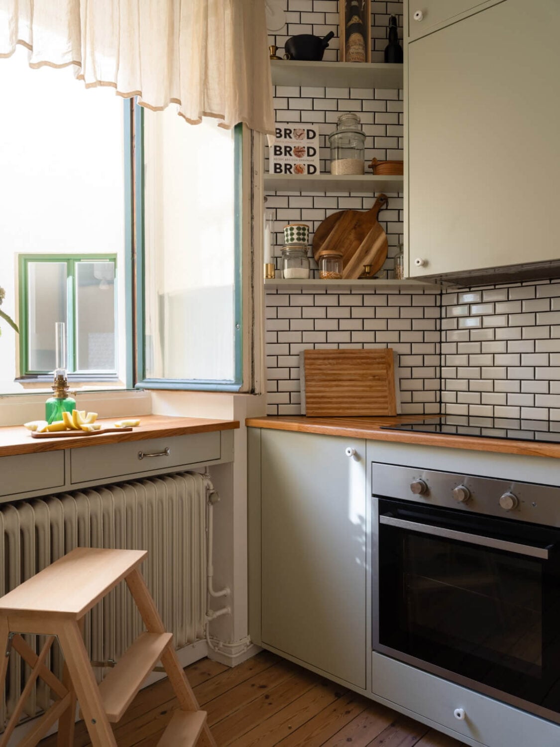 A Small Apartment with Green Color Accents and a Cozy Patio Terrace 20 green kitchen with shelves