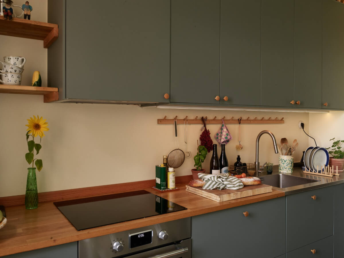 A Nature-Inspired Color Palette in a Stockholm Apartment 9 green kitchen wooden countertop