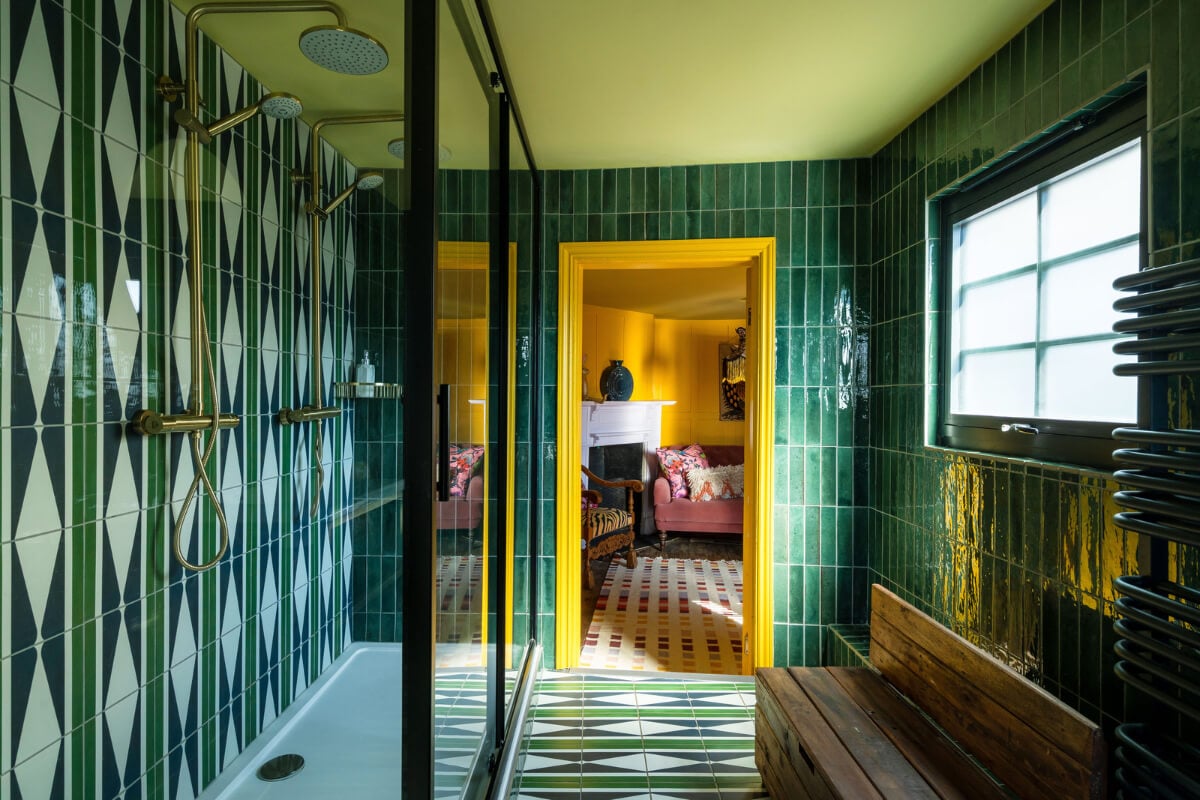 Colorful Design and Historic Features in a Charming English Home 13 green tiles bathroom yellow doorframe nordroom