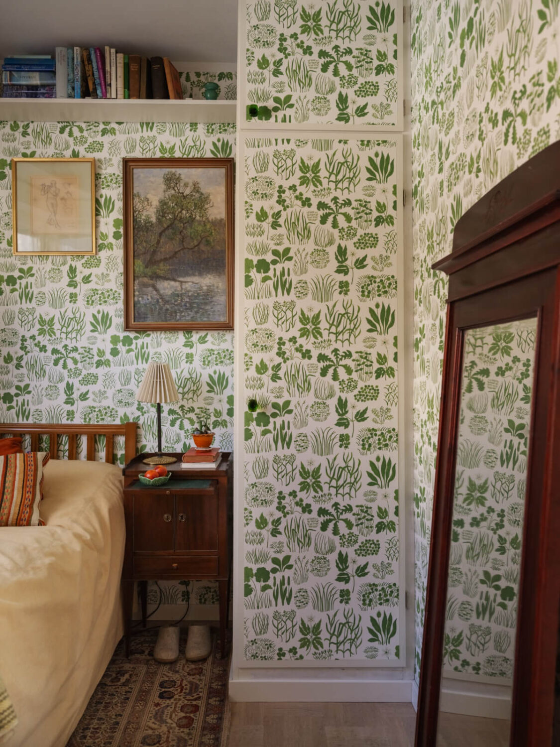 A Tiny Apartment Filled with Books and a Midcentury-Style Kitchen 21 green wallpaper small bedroom with shelf