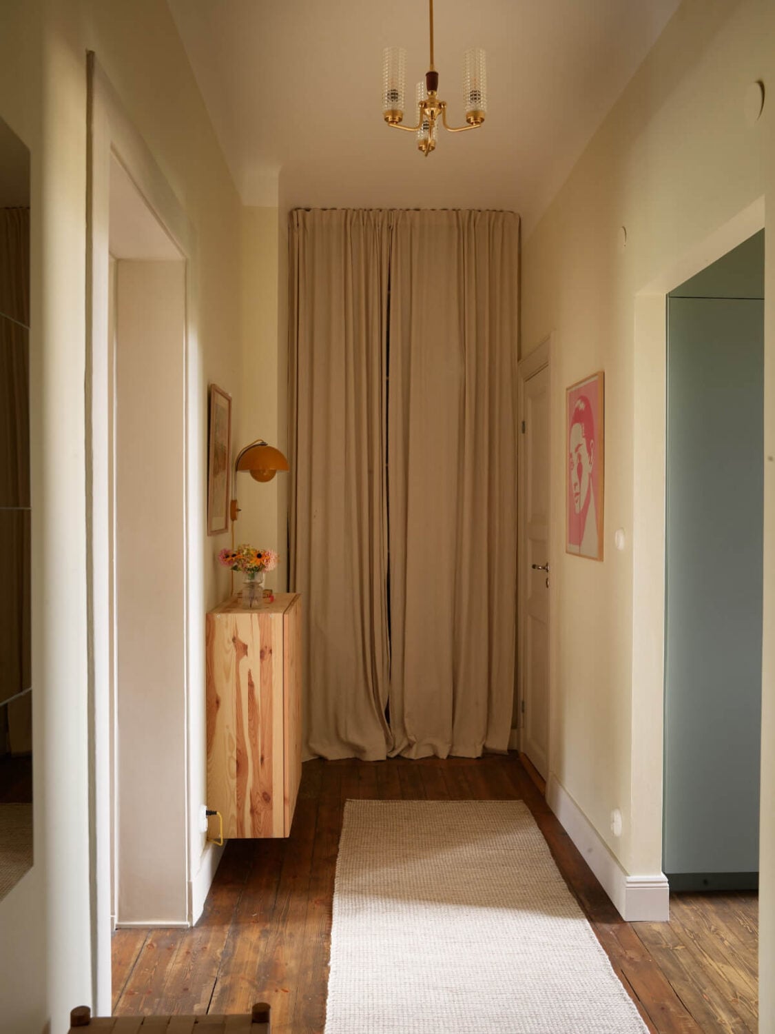 A Nature-Inspired Color Palette in a Stockholm Apartment 26 hall storage behind curtain