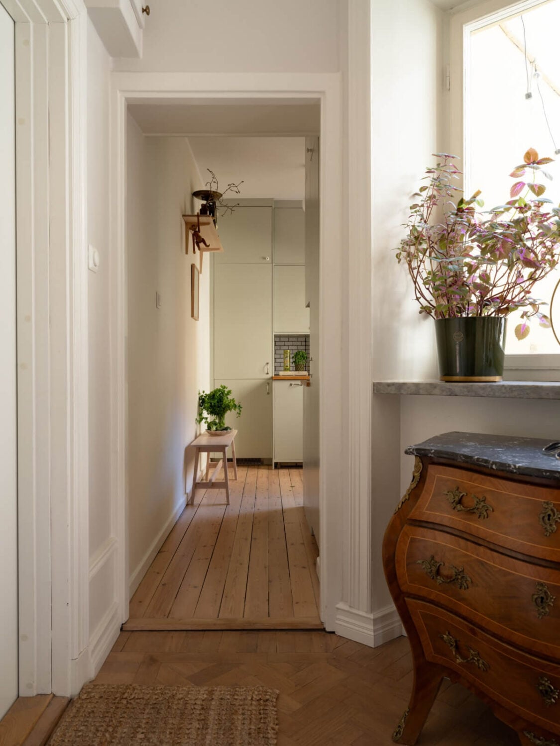 A Small Apartment with Green Color Accents and a Cozy Patio Terrace 17 hall to kitchen