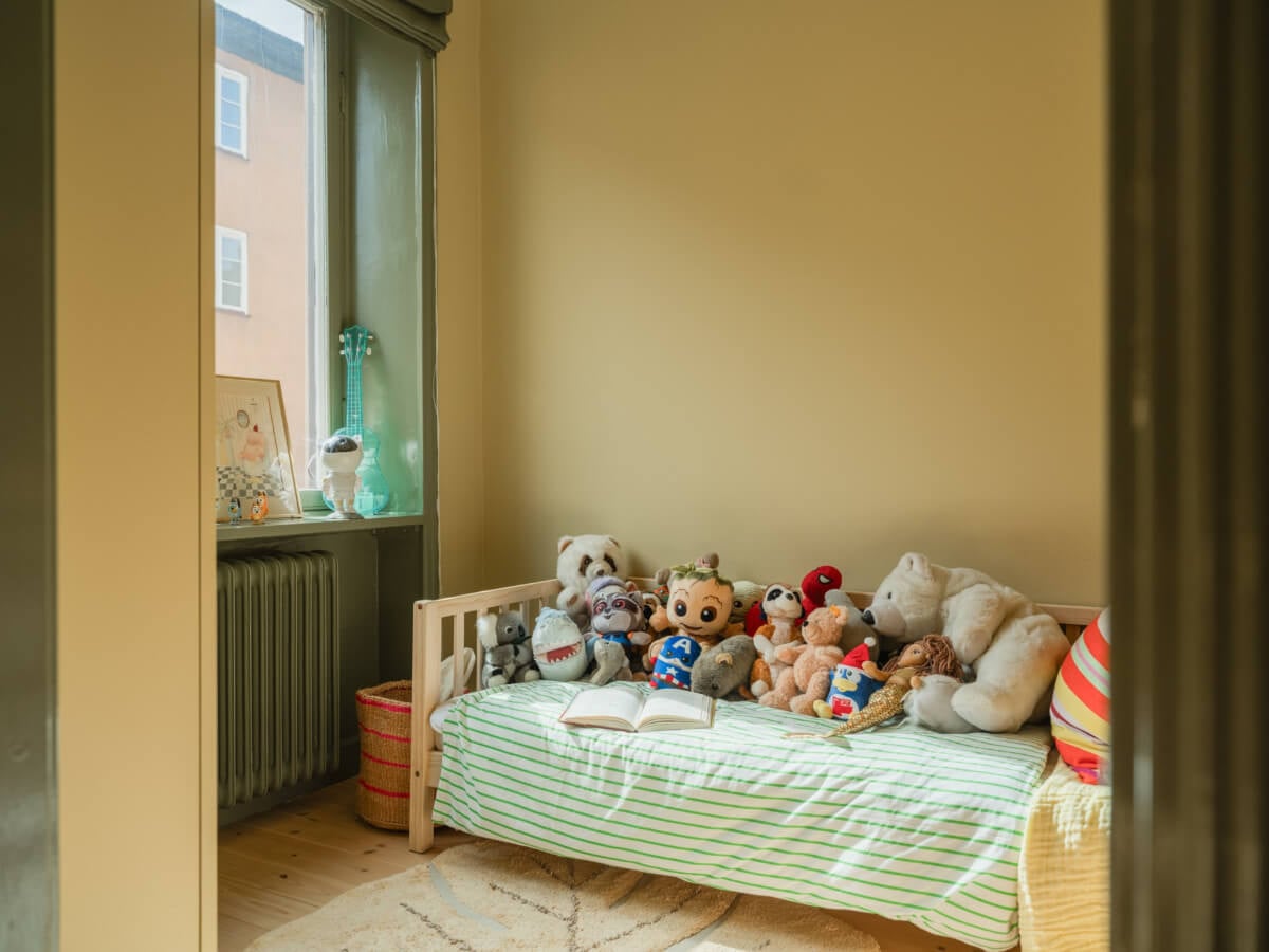 A Yellow and Green Color Palette in a Modern Swedish Apartment 11 kids bedroom green woodwork